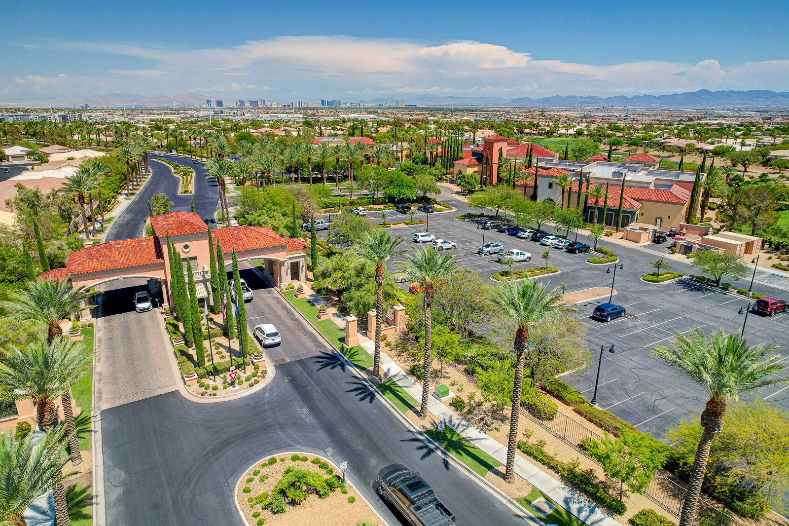 Aerial view of Siena's guard-gated entrance and roundabout with the Las Vegas Strip skyline in the distance