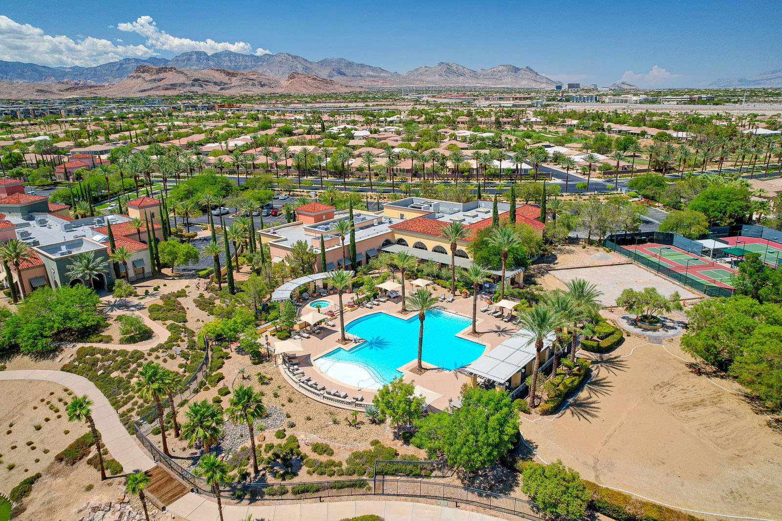 Aerial view of the Siena Fitness Center pool, spa, and sports courts with mountain views