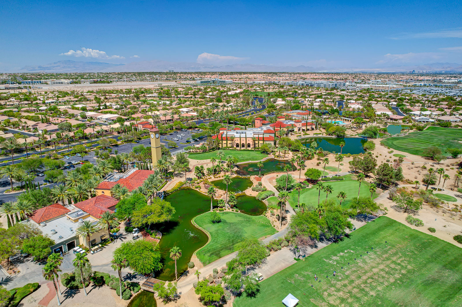 Aerial view of Siena Golf Club with the driving range, ponds, and Las Vegas Strip skyline in the distance