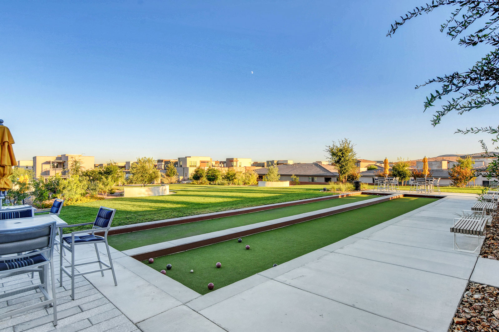 Bocce ball court and lawn seating area at the Outlook Club at twilight
