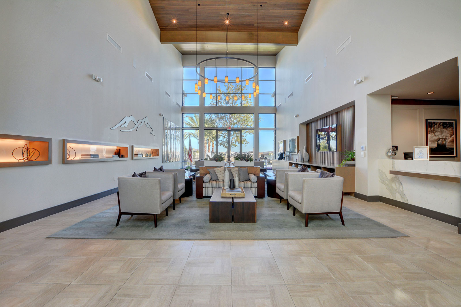 Clubhouse lobby with high ceilings, seating area, and reception desk at Regency at Summerlin