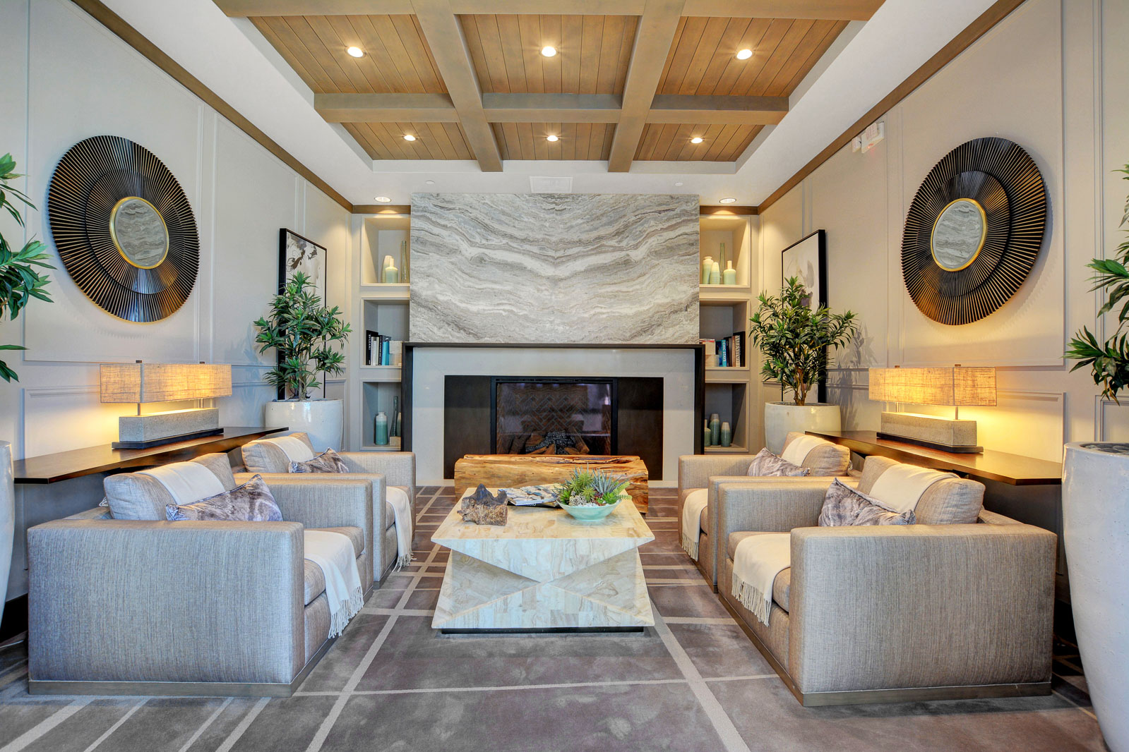 Clubhouse lounge with a stone fireplace and seating areas at Regency at Summerlin