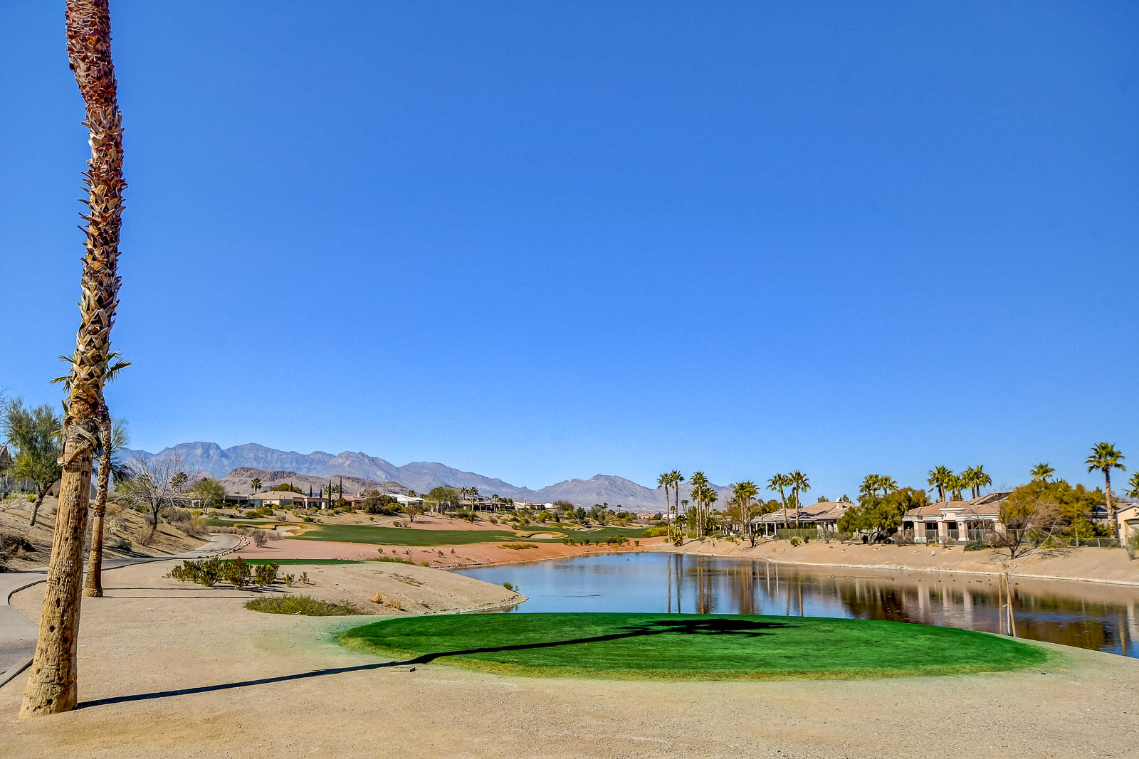 Golf green beside a pond at Siena Golf Club with mountain views in Las Vegas, Nevada