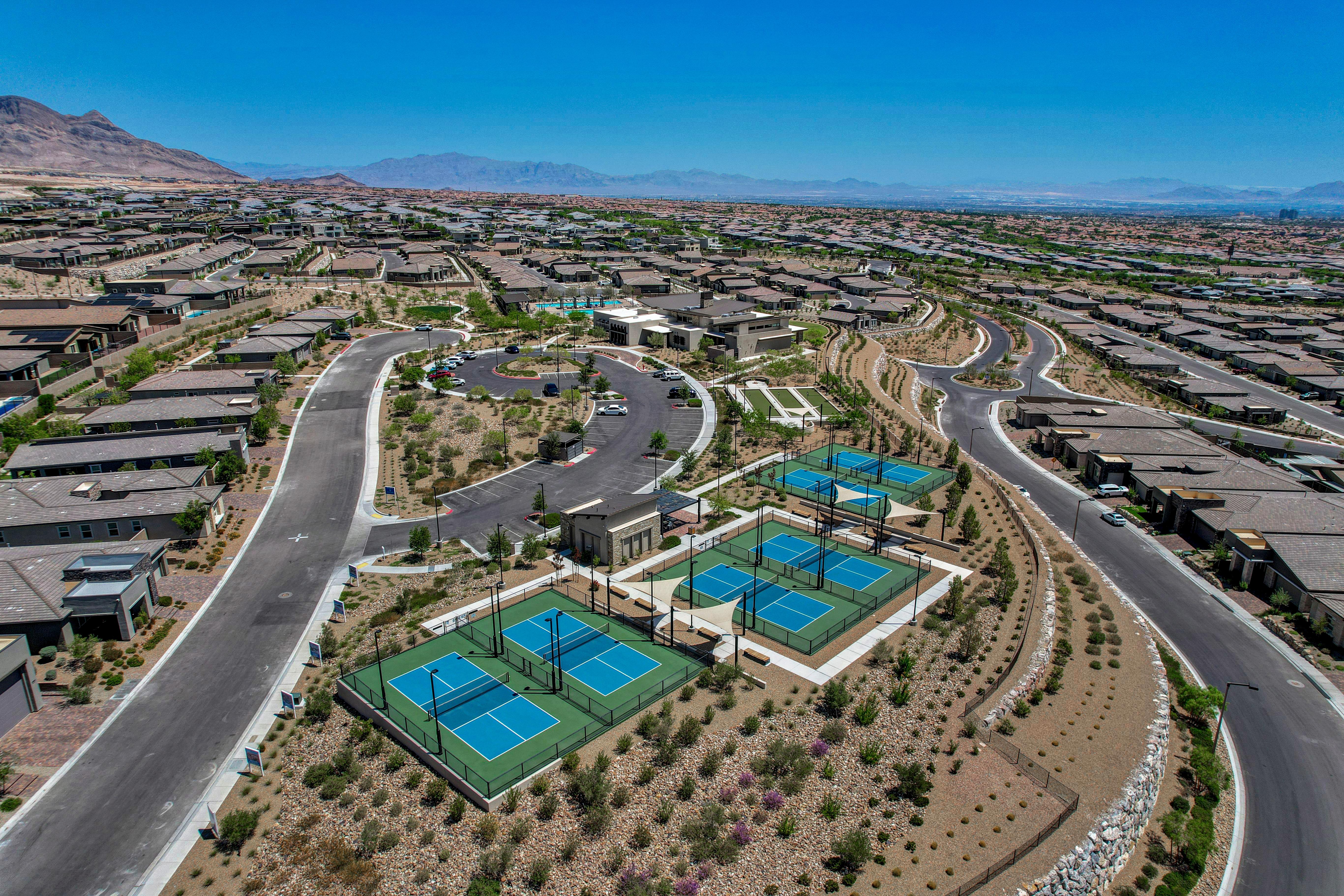 Aerial view of the Heritage at Stonebridge clubhouse, pool, and pickleball courts surrounded by the community's single-family homes