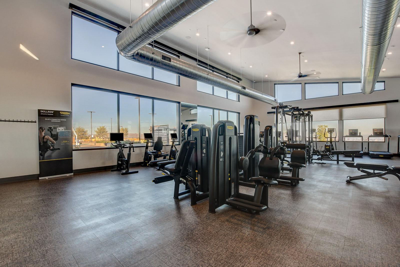Fitness center with cardio and weight equipment and valley views at the Heritage at Stonebridge clubhouse