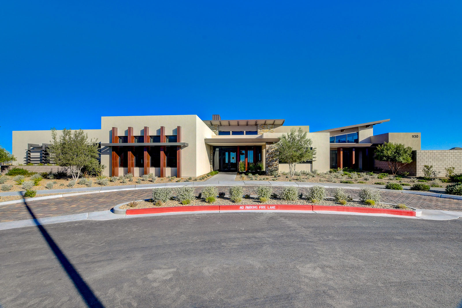 Heritage at Stonebridge clubhouse exterior with modern desert architecture and landscaped entrance