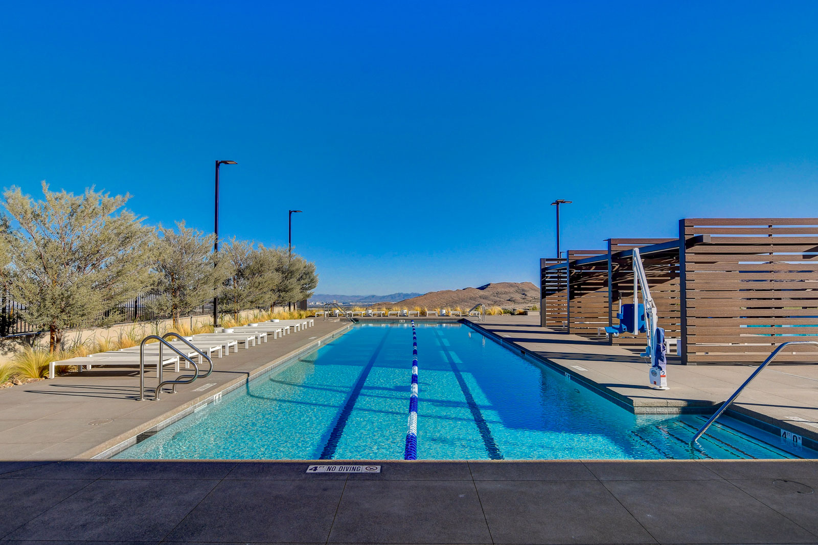 Outdoor lap pool with marked swim lanes and mountain views at the Heritage at Stonebridge clubhouse