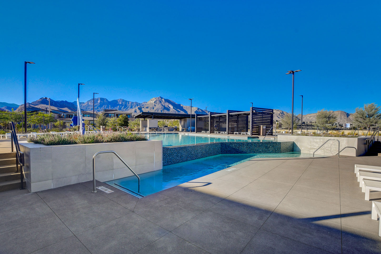 Pool with a tanning ledge and mountain views at the Heritage at Stonebridge clubhouse