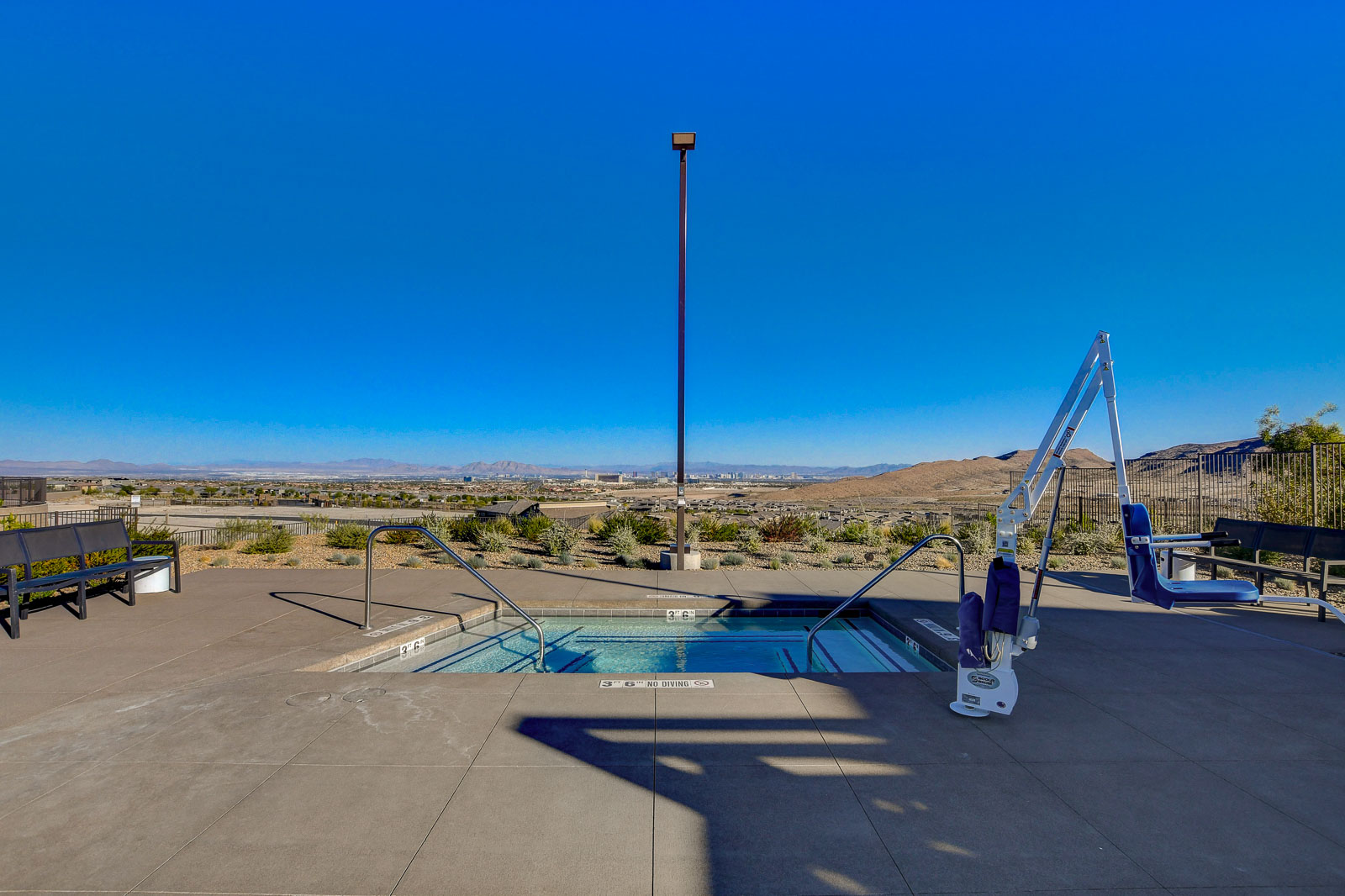 Spa pool with an accessibility lift overlooking the Las Vegas Valley and Strip skyline at Heritage at Stonebridge